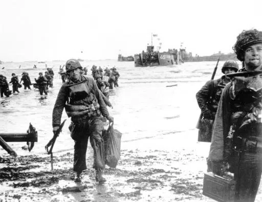 Carrying full equipment, American assault troops move onto a beachhead code-named Omaha Beach, on the northern coast of France on June 6, 1944, during the Allied invasion of the Normandy coast. The greatest armada ever assembled, nearly 7,000 ships and boats, supported by more than 11,000 planes, carried almost 133,000 troops across the Channel to establish toeholds on five heavily defended beaches stretched across 80 kilometers (50 miles) of Normandy coast. More than 9,000 Allied soldiers were 