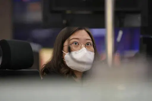 A currency trader watches computer monitors at a foreign exchange dealing room in Seoul, South Korea, Thursday, April 28, 2022. (AP Photo/Lee Jin-man)