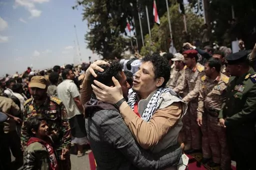 Houthi prisoners are greeted as they arrive to Sanaa airport, Friday, April 14, 2023. An exchange of more than 800 prisoners linked to Yemen's long-running war them began Friday, the International Committee for the Red Cross said. The three-day operations will see flights transport prisoners between Saudi Arabia and Yemen's capital, Sanaa, long held by the Iranian-backed Houthi rebels. ((AP Photo/Hani Mohammed)