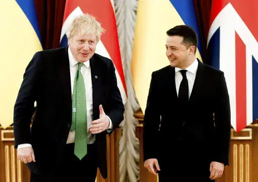 Britain's Prime Minister Boris Johnson, left, reacts with Ukrainian President Volodymyr Zelenskyy, prior to their talks amid rising tension between Ukraine and Russia, at the presidential palace, in Kyiv, Ukraine, Tuesday, Feb. 1, 2022.  (Peter Nicholls/Pool Photo via AP)