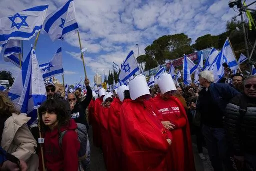 Israelis protest against plans by Prime Minister Benjamin Netanyahu's new government to overhaul the judicial system, outside the Knesset, Israel's parliament, in Jerusalem, Monday, Feb. 13, 2023. Thousands of Israelis protested outside the country's parliament on Monday ahead of a preliminary vote on a bill that would give politicians greater power over appointing judges, part of a judicial overhaul proposed by Prime Minister Benjamin Netanyahu's government. (AP Photo/Ohad Zwigenberg)