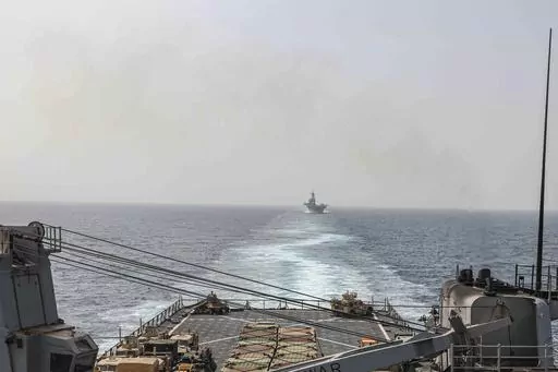 In this image provided by the U.S. Navy, the amphibious dock landing ship USS Carter Hall and amphibious assault ship USS Bataan transit the Bab al-Mandeb strait on Aug. 9, 2023. The top commander of U.S. naval forces in the Middle East says Yemen’s Houthi rebels are showing no signs of ending their “reckless” attacks on commercial ships in the Red Sea. But Vice Adm. Brad Cooper said in an Associated Press interview on Saturday that more nations are joining the international maritime missi