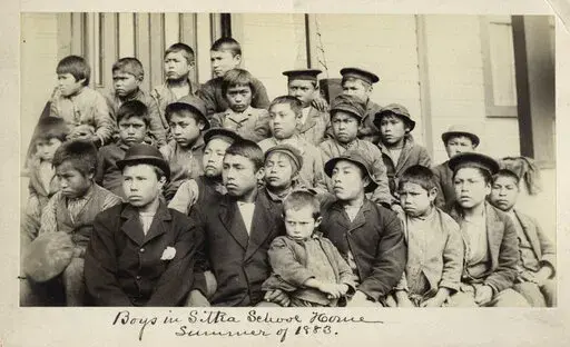 This photo made available by the Presbyterian Historical Society, Philadelphia shows students at a Presbyterian boarding school in Sitka, Alaska in the summer of 1883. U.S. Catholic and Protestant denominations operated more than 150 boarding schools between the 19th and 20th centuries. Native American and Alaskan Native children were regularly severed from their tribal families, customs, language and religion and brought to the schools in a push to assimilate and Christianize them. (Presbyteria