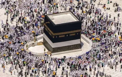 Muslim pilgrims walk around the Kaaba, the cubic building at the Grand Mosque, during the annual hajj pilgrimage, in Mecca, Saudi Arabia, on July 10, 2022. Islam's annual hajj pilgrimage in Saudi Arabia will return to pre-pandemic levels in 2023 after restrictions saw the annual religious commemoration curtailed over concerns about the coronavirus, authorities say. (AP Photo/Amr Nabil, File)